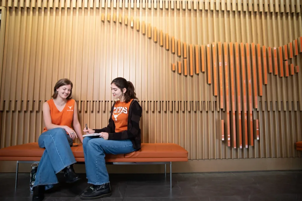 Students talking at the Admissions Welcome Center on The University of Texas at Austin campus